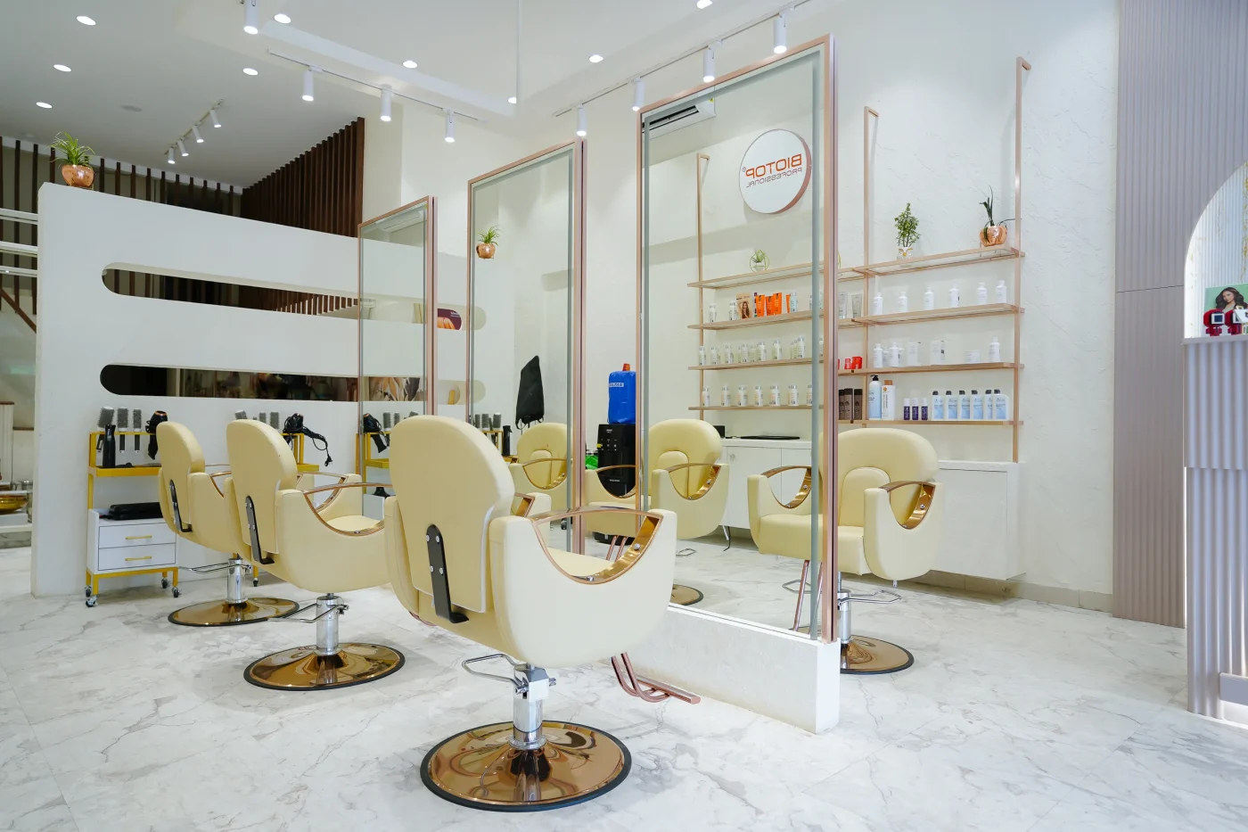 Inside Ally 21 Baner: cream chairs, marble floor and brass mirrors