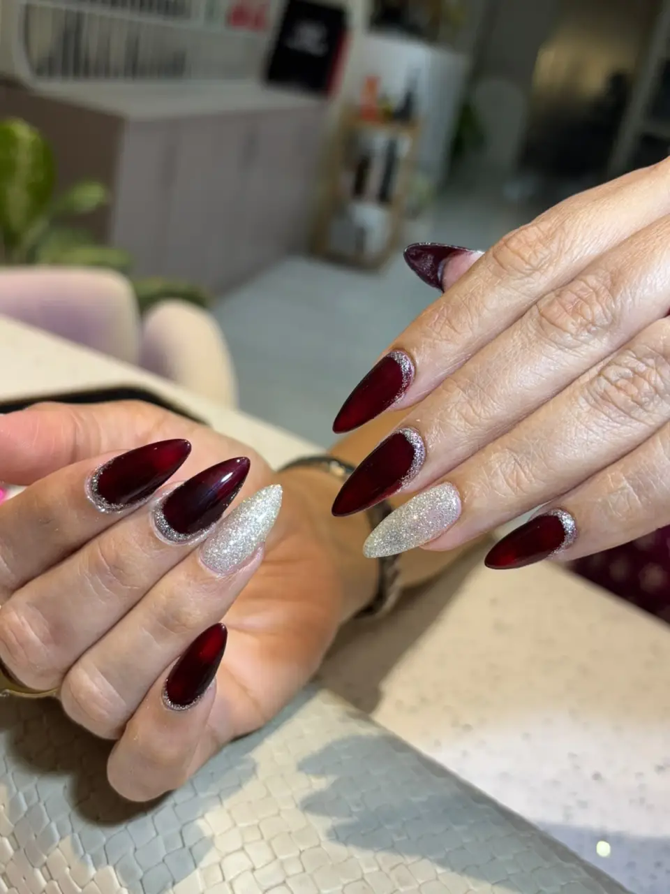 Burgundy almond extensions with a glitter accent